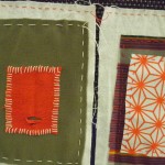 various colours of rectangular shapes handstitched in layers