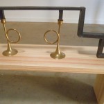 a sculture of brass candlesticks with a metal form inserted